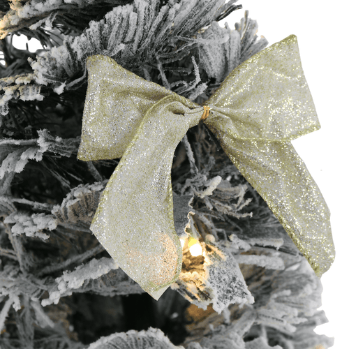 gold glitter bow on flocked christmas tree