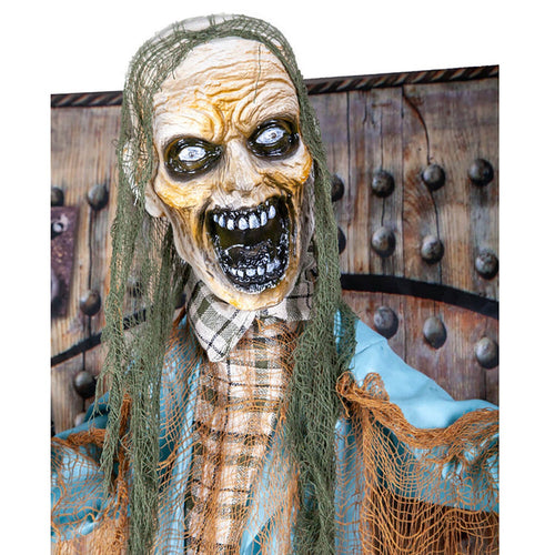Close up of the head of an animated Zombie figure with black gaping mouth