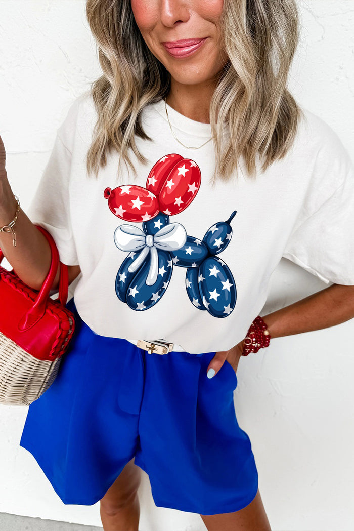 Cream graphic t-shirt featuring a red, white, and blue balloon dog design, styled casually for summer Americana outfits from The Pink Doxie Boutique.