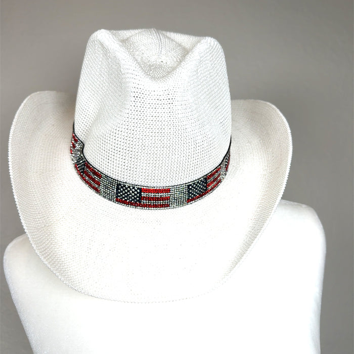 White rhinestone cowboy hat with a structured western brim, pinched crown, and sparkling American flag band.