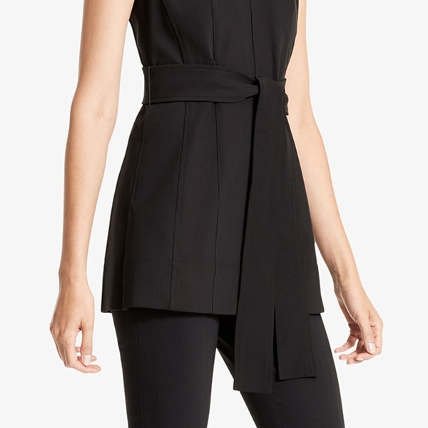 Side image of a woman standing wearing the Angelina top in Black | Exclude