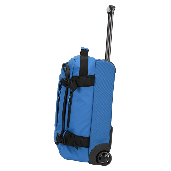 side view of trolley case in blue with telescopic handle fully extended, inline wheels and pockets