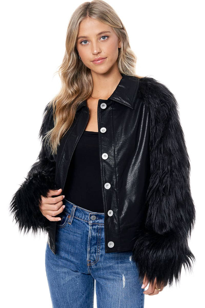 Black cropped collared jacket with a faux leather body, button front, and voluminous black faux fur sleeves.