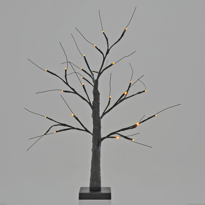 Halloween black twig tree lit up with orange lights