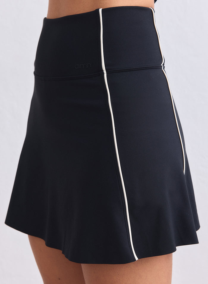Korkeavyötäröiset mustat Sense Contrast Skort -skortsit valkoisilla tereillä ja hienovaraisella aim'n-logolla. [XS-165cm]