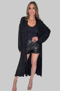 Black long open-front duster jacket with studded embellishment, relaxed drape, and a flowy hem.
