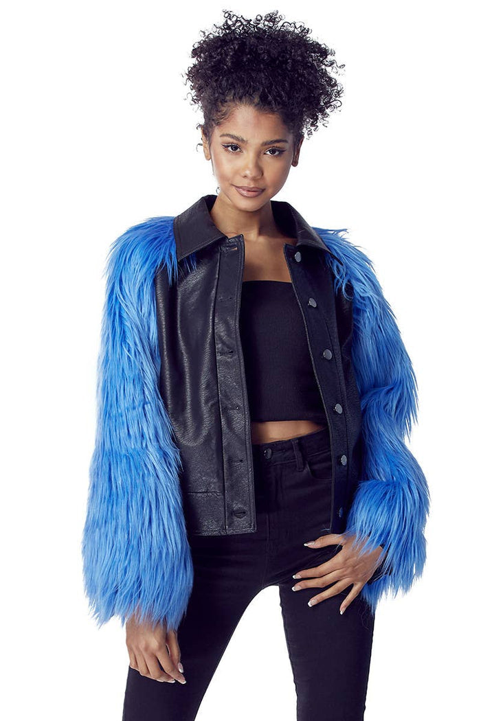 Blue faux fur sleeve jacket with a black faux leather body, point collar, and snap front closure.