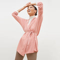 Side image of a woman standing wearing the Daphne sweater in Rose Heather | Lead