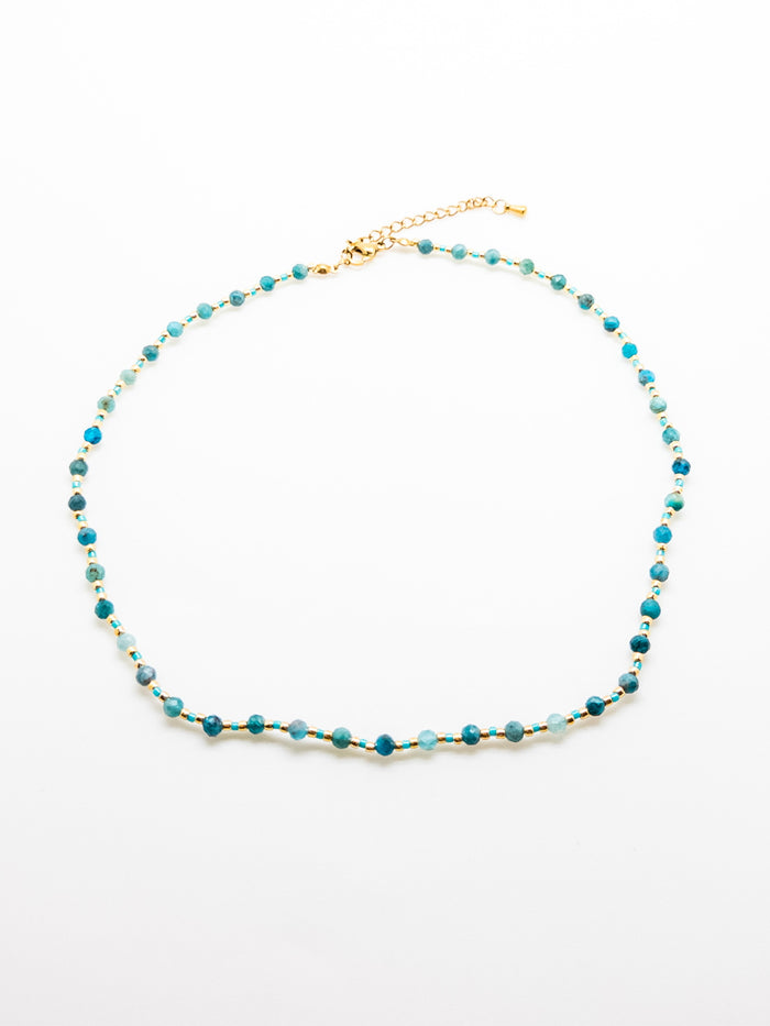 The Faye Necklace in Teal featuring apatite beads and stainless steel accents on a white background.