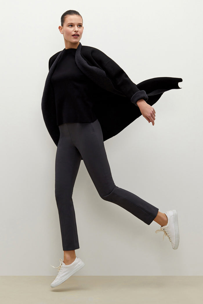 Front image of a woman standing wearing the foster pant in monsoon | Grid Hover | Exclude