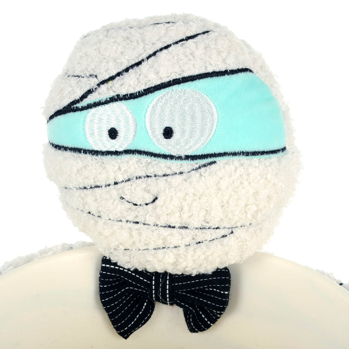 Close up of the face and bow tie of a mummy Halloween treats dish
