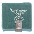Teal hand towel with cow design and 'Country Club' label on a white background
