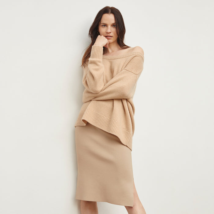 Front image of a woman standing wearing the Harlem skirt in latte