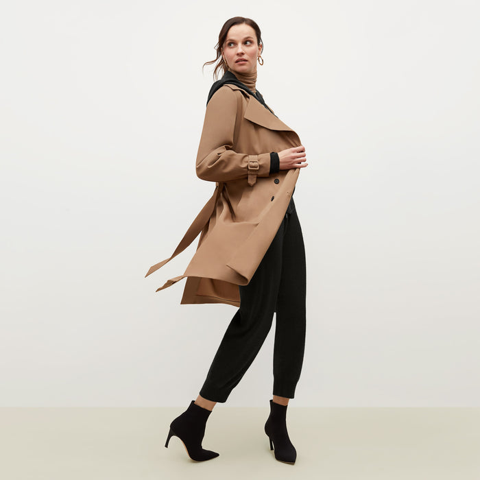 Side image of a woman standing wearing the Jensen trench in Saddle | Lead
