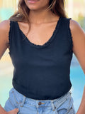 Lori Italian Tank in black on model. Features worn raw edge neckline and sleeve. front view