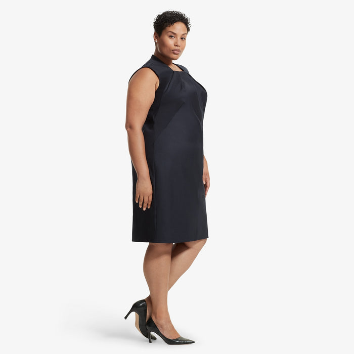 Side image of a woman standing wearing the Lucinda dress sharkskin in Ink
