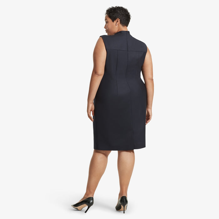 Back image of a woman standing wearing the Lucinda dress sharkskin in Ink