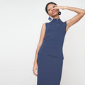 Front image of a woman standing wearing the Malki Top in jardigan knit in Baltic Blue | Lead