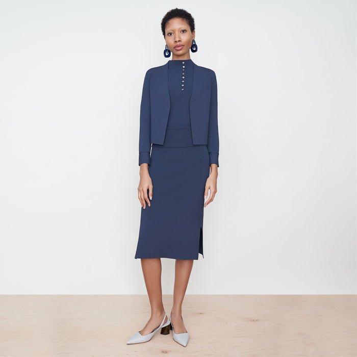 Front image of a woman standing wearing the Malki Top in jardigan knit in Baltic Blue