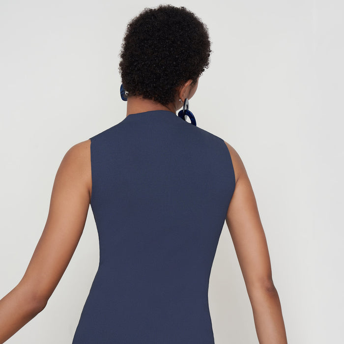 Back image of a woman standing wearing the Malki Top in jardigan knit in Baltic Blue