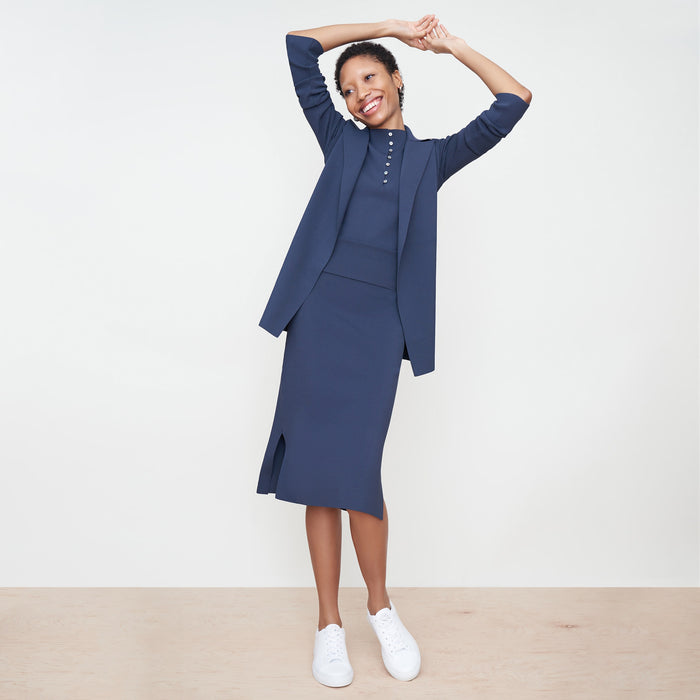 Front image of a woman standing wearing the Malki Top in jardigan knit in Baltic Blue