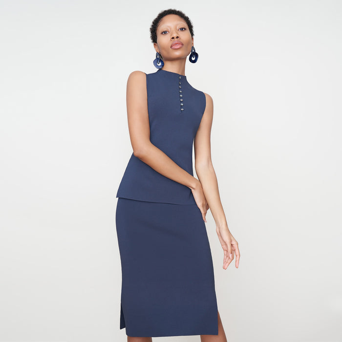 Front image of a woman standing wearing the Malki Top in jardigan knit in Baltic Blue