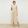 Front image of a woman standing wearing the Malki top in latte  | Lead
