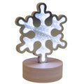 Snowflake-shaped night light on a white background