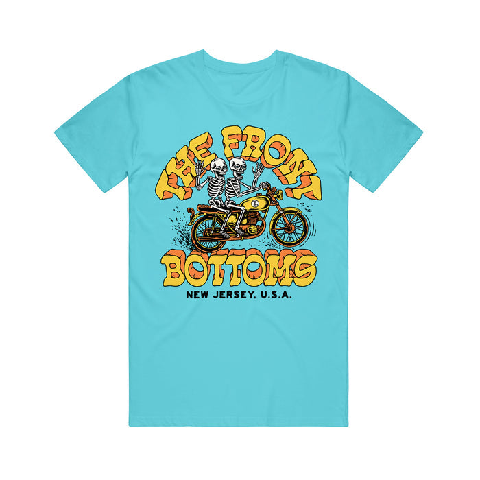 A Lagoon Blue T-Shirt from The Front Bottoms features a cartoon skeleton on a yellow motorcycle, bold yellow "The Front Bottoms," and "New Jersey, U.S.A." below—a must-have for fans.