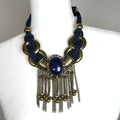 Navy and gold short statement necklace with rope-style detailing, gold metallic discs, and layered tassel chain fringe.