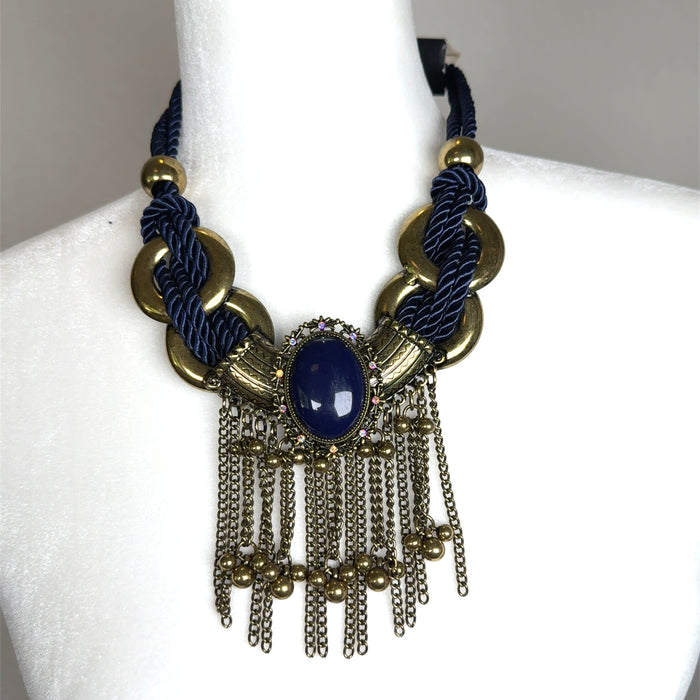 Navy and gold short statement necklace with rope-style detailing, gold metallic discs, and layered tassel chain fringe.
