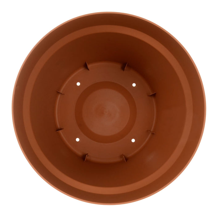 View inside of round terracotta planter with drainage holes