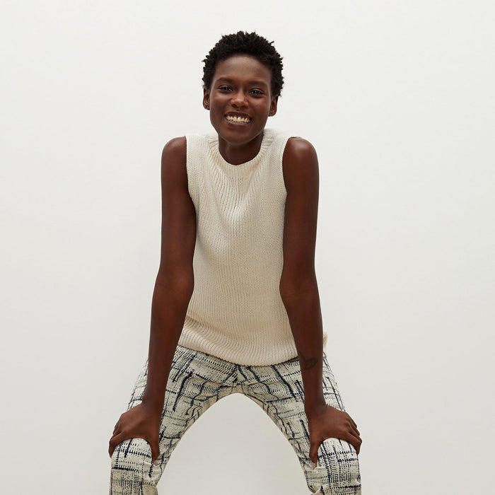 Front image of a woman standing wearing the Spardel top in ivory | Exclude