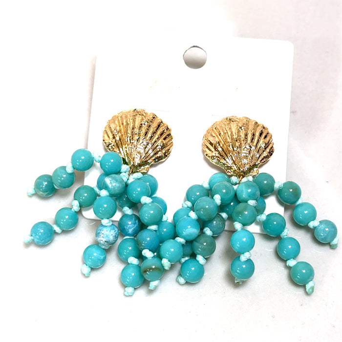 Turquoise beaded earrings with a golden shell accent, designed as a coastal-inspired statement jewelry piece.