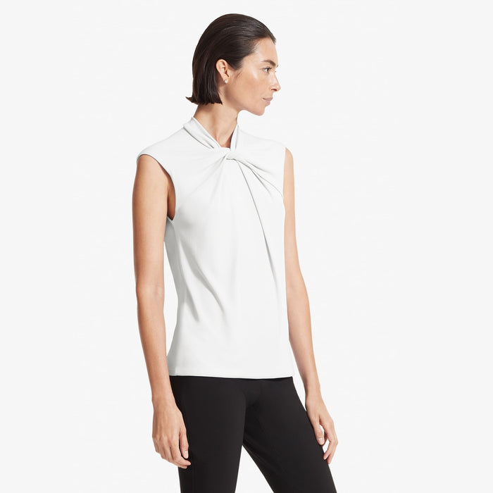 Side image of a woman standing wearing the Walters top knit crepe in Ivory