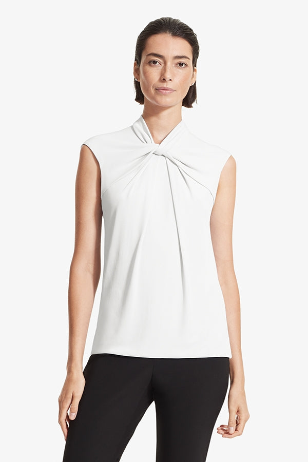Front image of a woman standing wearing the Walters top knit crepe in Ivory | Grid | Exclude